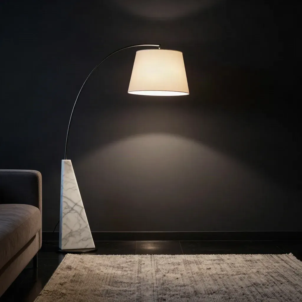 Mora Arc Floor Lamp glowing beside a sofa with a marble base and curved black arm